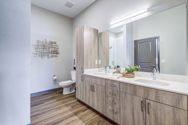 Modern bathroom with sleek fixtures and ample lighting in Novus Apartments, offering luxury living spaces in a prime location