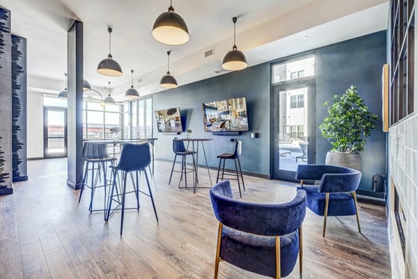 Sure, I can help with that Following the template for interior spaces and incorporating the theme and property name:

Clubhouse featuring modern decor and leisure spaces at Novus Apartments