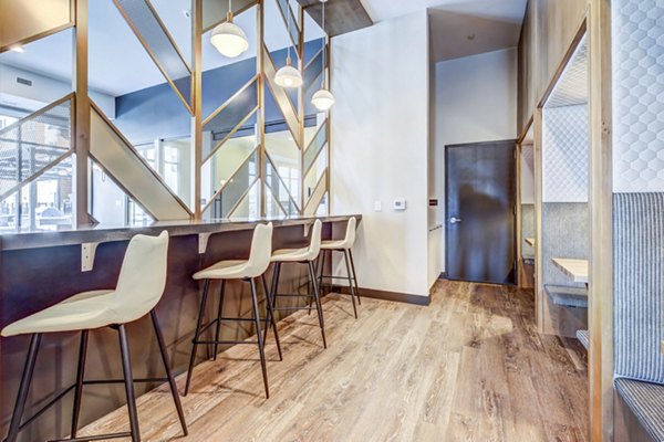 Clubhouse featuring modern design and entertainment spaces at Novus Apartments