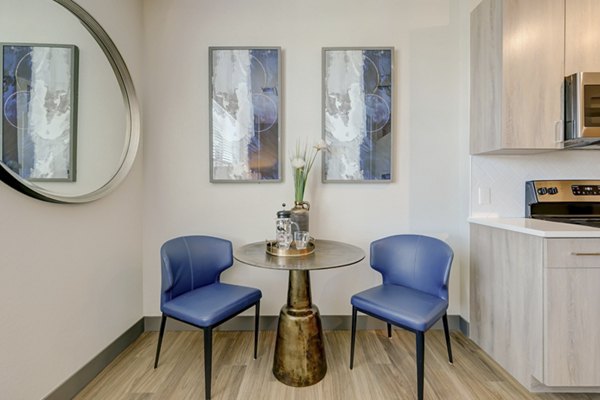 Dining area with modern furnishings in Novus Apartments, featuring elegant dÃ©cor and ample natural light