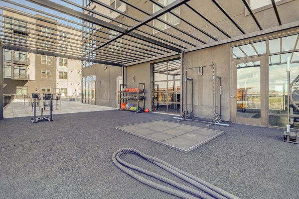 Spacious fitness center with modern equipment at Novus Apartments, ideal for maintaining an active lifestyle in luxury surroundings