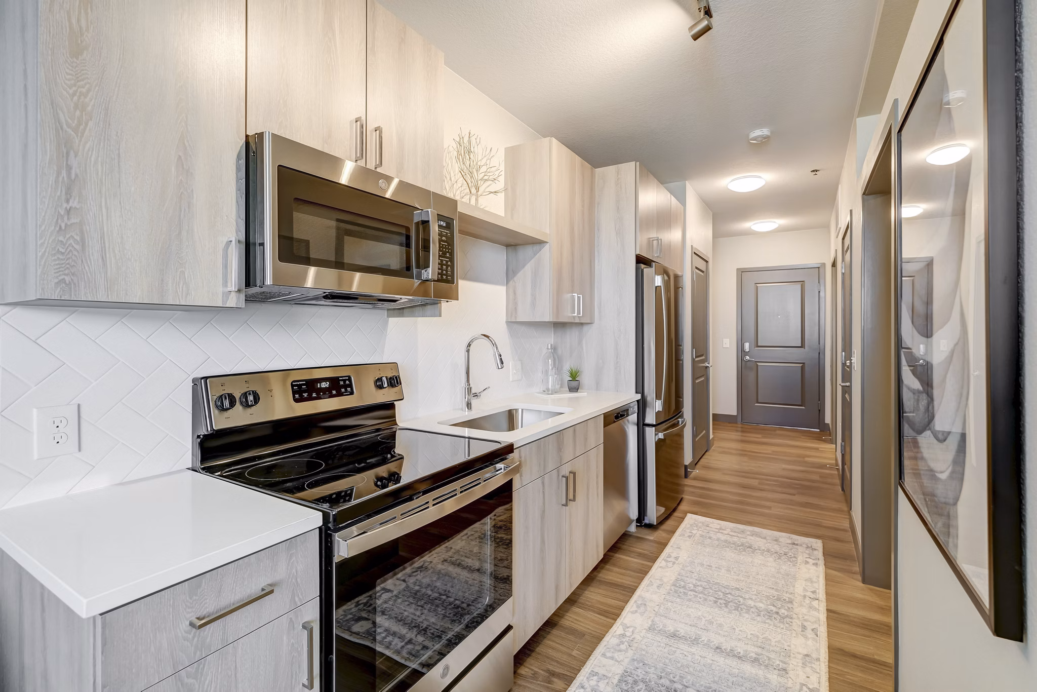 Modern kitchen featuring stainless steel appliances at Novus Apartments