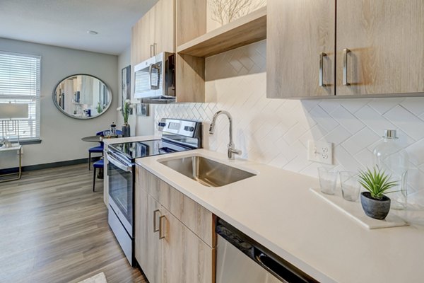 Kitchens with granite countertops and stainless steel appliances at Novus Apartments