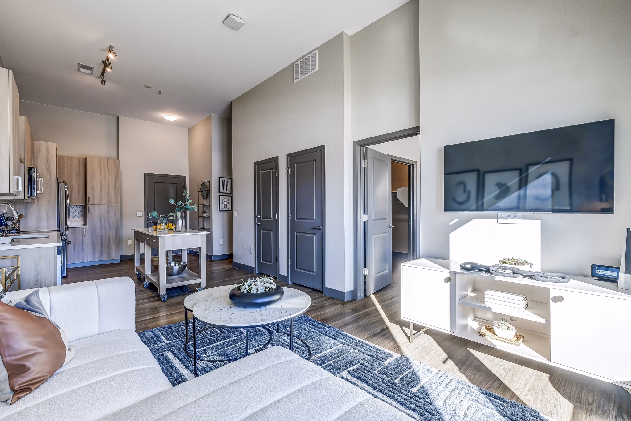 Modern living room with open layout and stylish decor at Novus Apartments, enhancing luxury apartment living experience