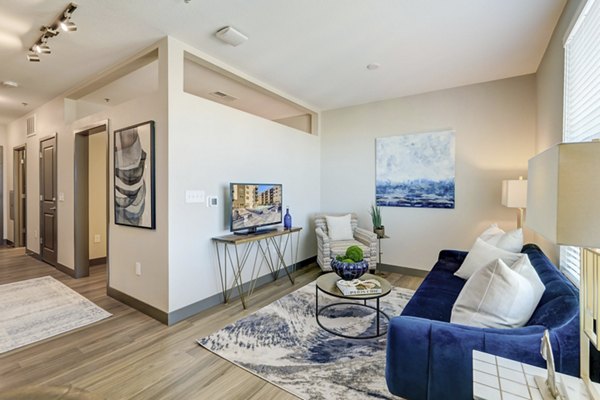 Modern living room with stylish furniture and natural light at Novus Apartments, offering luxury living