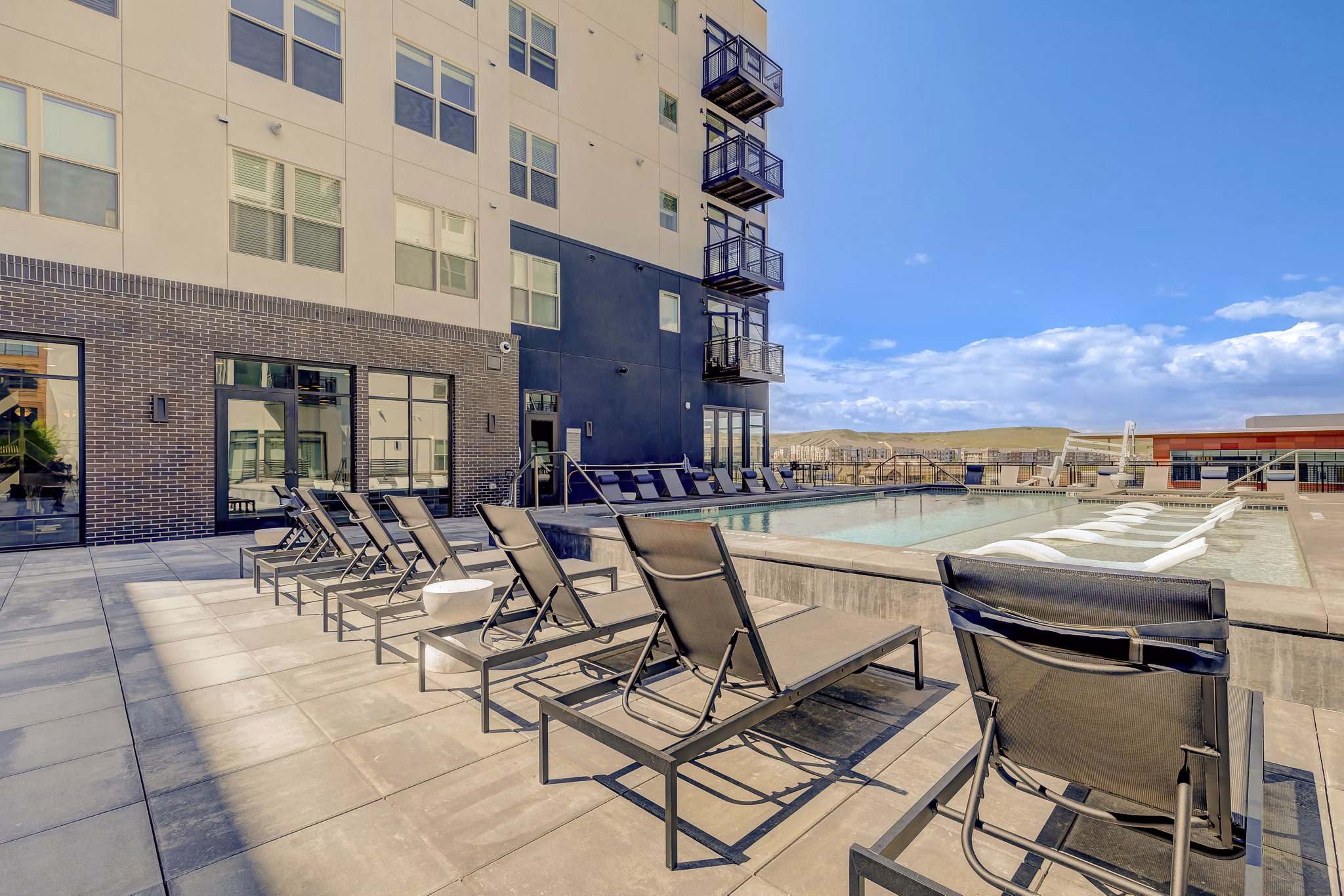 Resort-style pool at Novus Apartments with lush landscaping, providing luxury living at Phoenix's premier residential community
