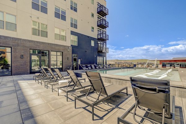 Resort-style pool at Novus Apartments with lush landscaping, providing luxury living at Phoenix's premier residential community