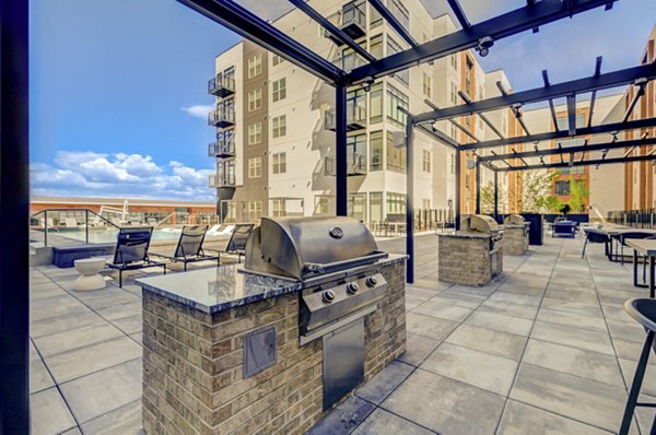 Grill area with sleek outdoor kitchen amenities at Novus Apartments, perfect for gatherings and dining al fresco