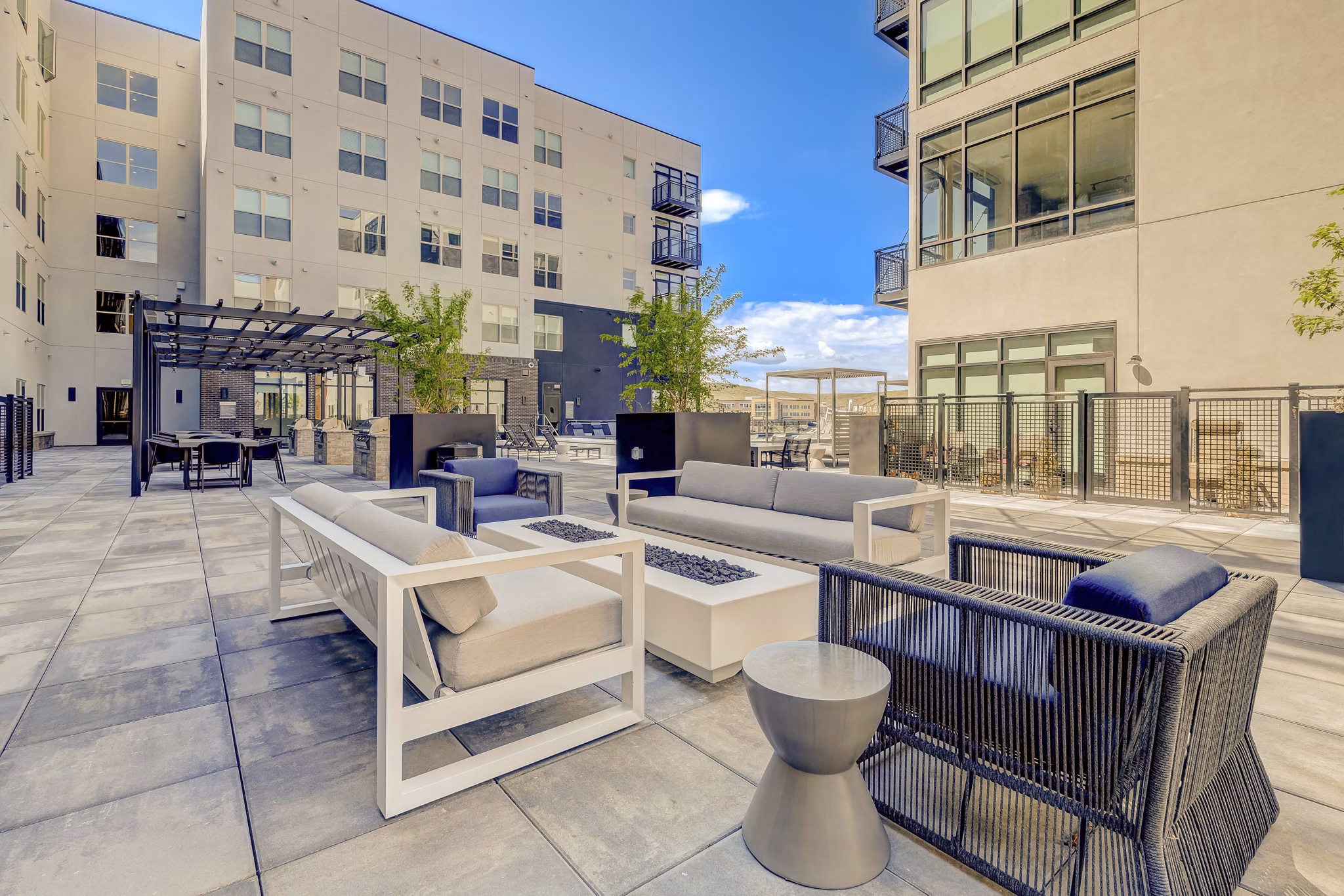 Inviting fire pit area with cozy seating at Novus Apartments, perfect for evening gatherings and relaxation