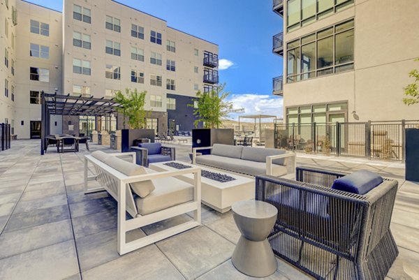 Inviting fire pit area with cozy seating at Novus Apartments, perfect for evening gatherings and relaxation