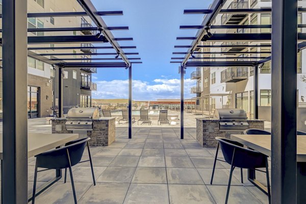 Modern outdoor grill area at Novus Apartments, offering spacious cooking facilities and seating for resident gatherings