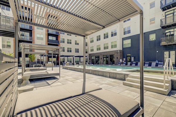 Spacious patio with modern furnishings at Novus Apartments