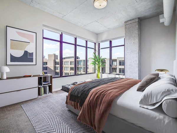Cozy bedroom with modern decor at The Flats at East Bank Apartments