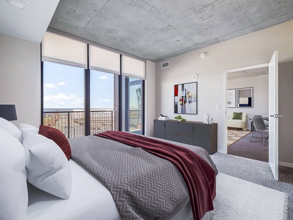 Cozy bedroom with modern furnishings at The Flats at East Bank Apartments