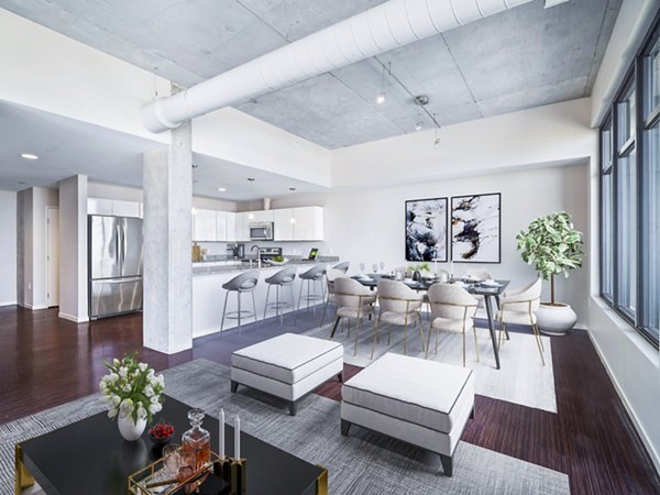 Dining room featuring modern furniture and stylish lighting at The Flats at East Bank Apartments