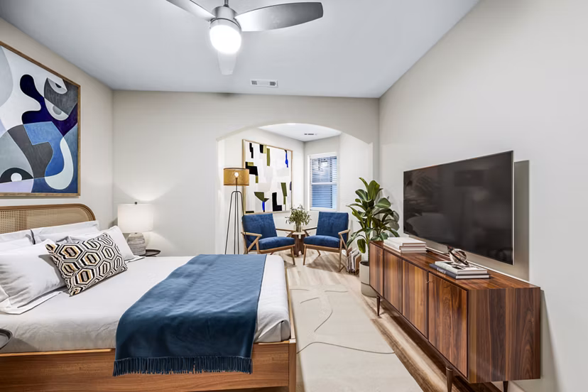 Cozy bedroom with modern furnishings at The Avens at Dedham Station Apartments