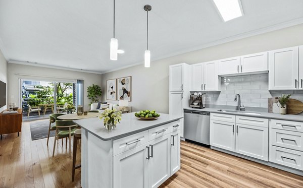 Kitchens featuring modern fixtures and stainless steel appliances at The Avens at Dedham Station Apartments