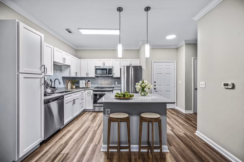 Kitchen with stainless steel appliances and quartz countertops at The Avens at Dedham Station Apartments