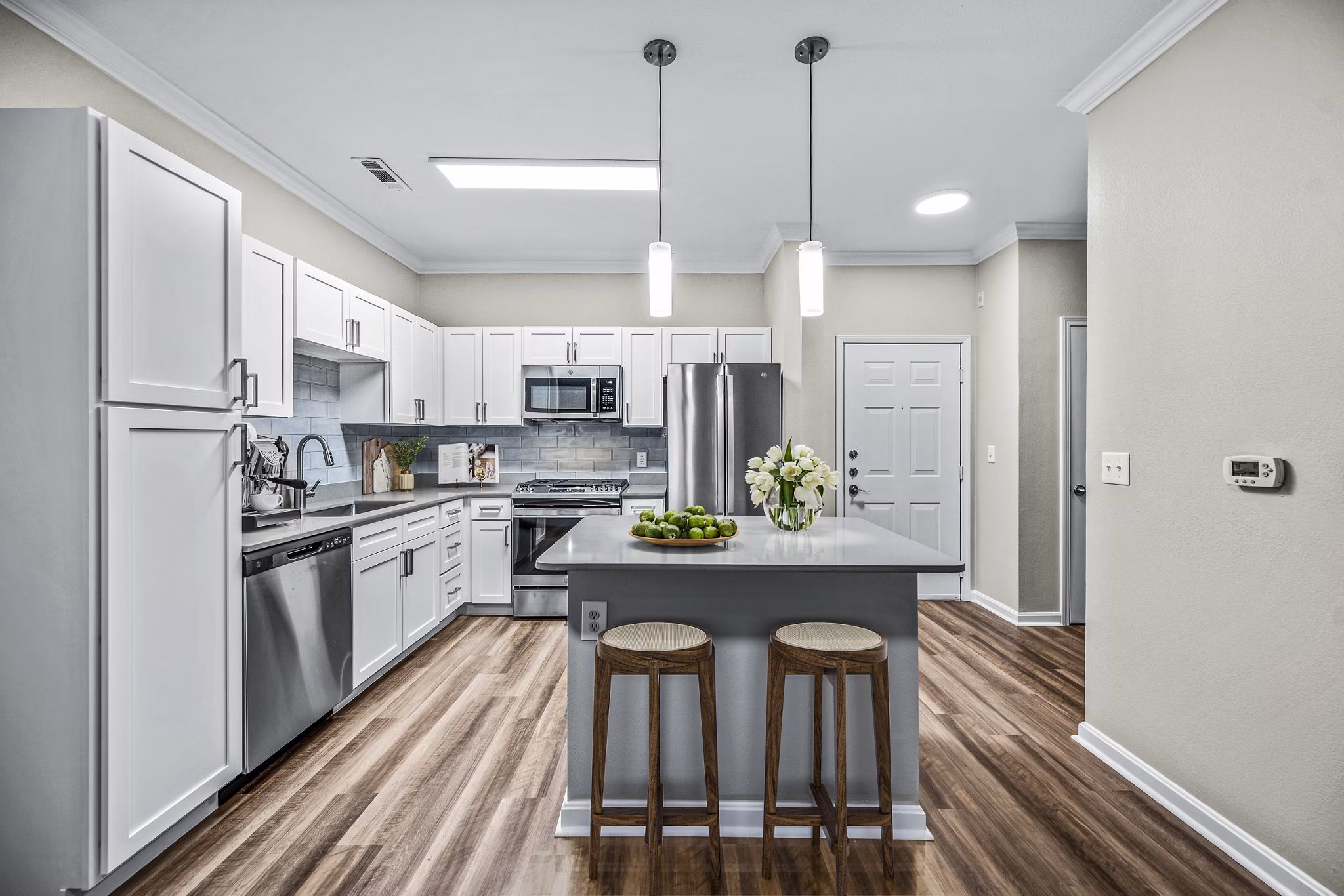 Kitchen with stainless steel appliances and quartz countertops at The Avens at Dedham Station Apartments