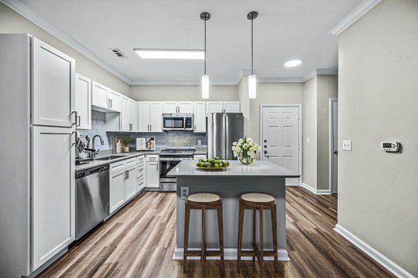 Kitchen with stainless steel appliances and quartz countertops at The Avens at Dedham Station Apartments