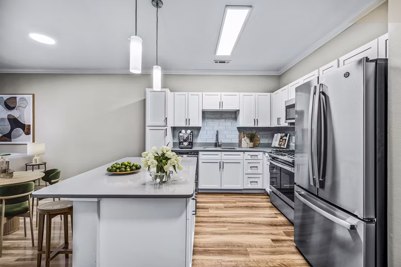 Modern kitchen with sleek countertops and stainless steel appliances at The Avens at Dedham Station Apartments