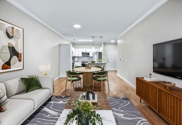 Spacious living room with modern decor in The Avens at Dedham Station Apartments