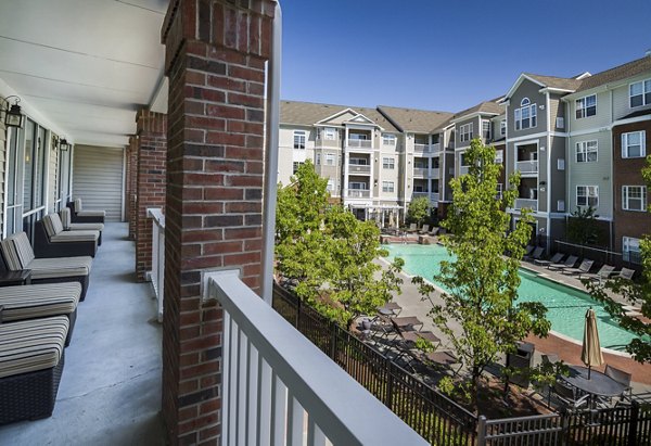 Spacious patio at The Avens Dedham Station Apartments featuring stylish outdoor seating and lush greenery