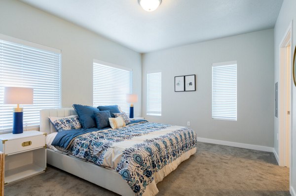 Luxurious bedroom with sleek furnishings and ample natural light at Millpond Apartments