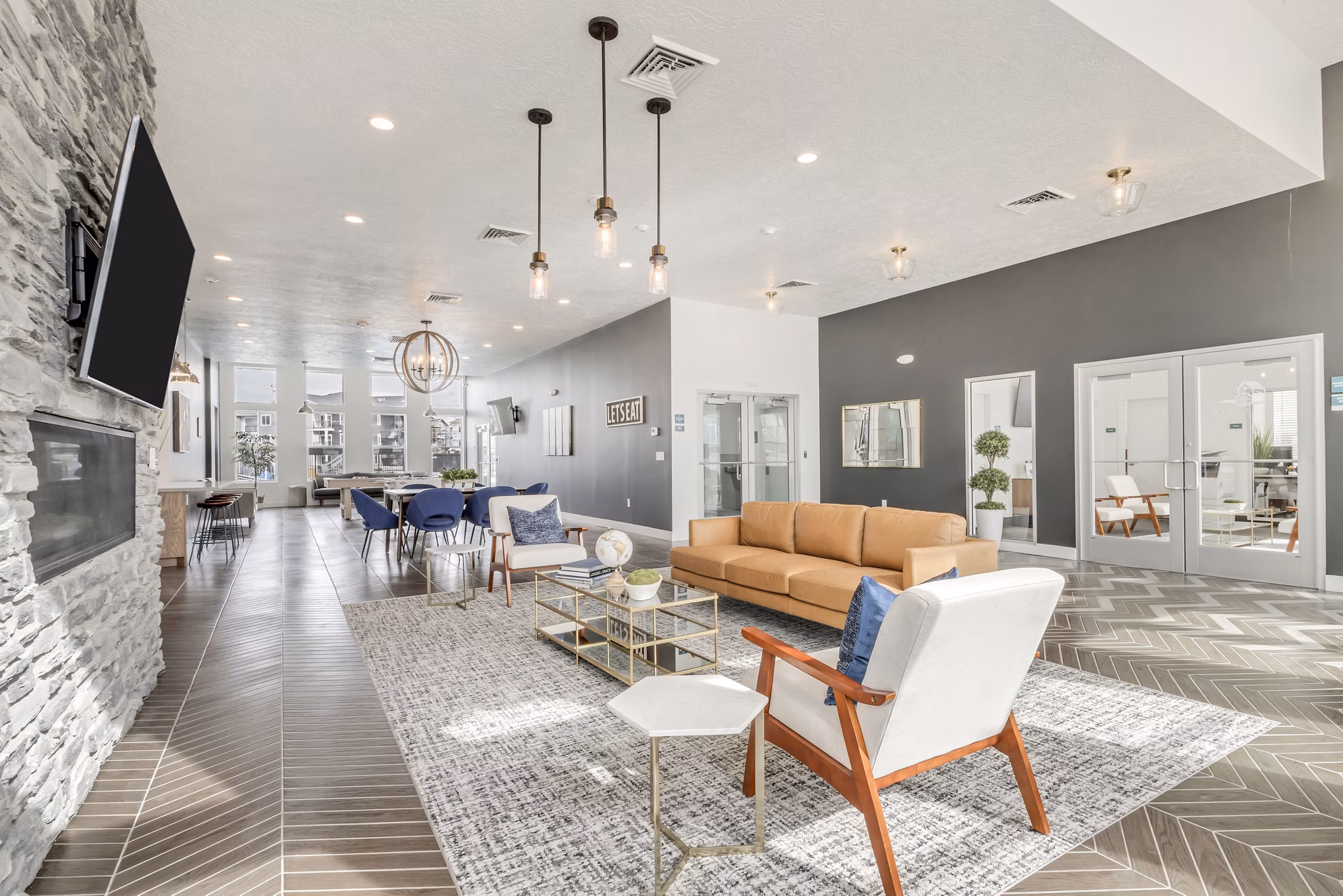 Clubhouse featuring modern design and spacious seating at Millpond Apartments