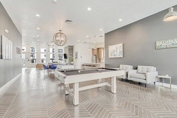 Modern clubhouse featuring lounge seating and fireplace at Millpond Apartments clubhouse