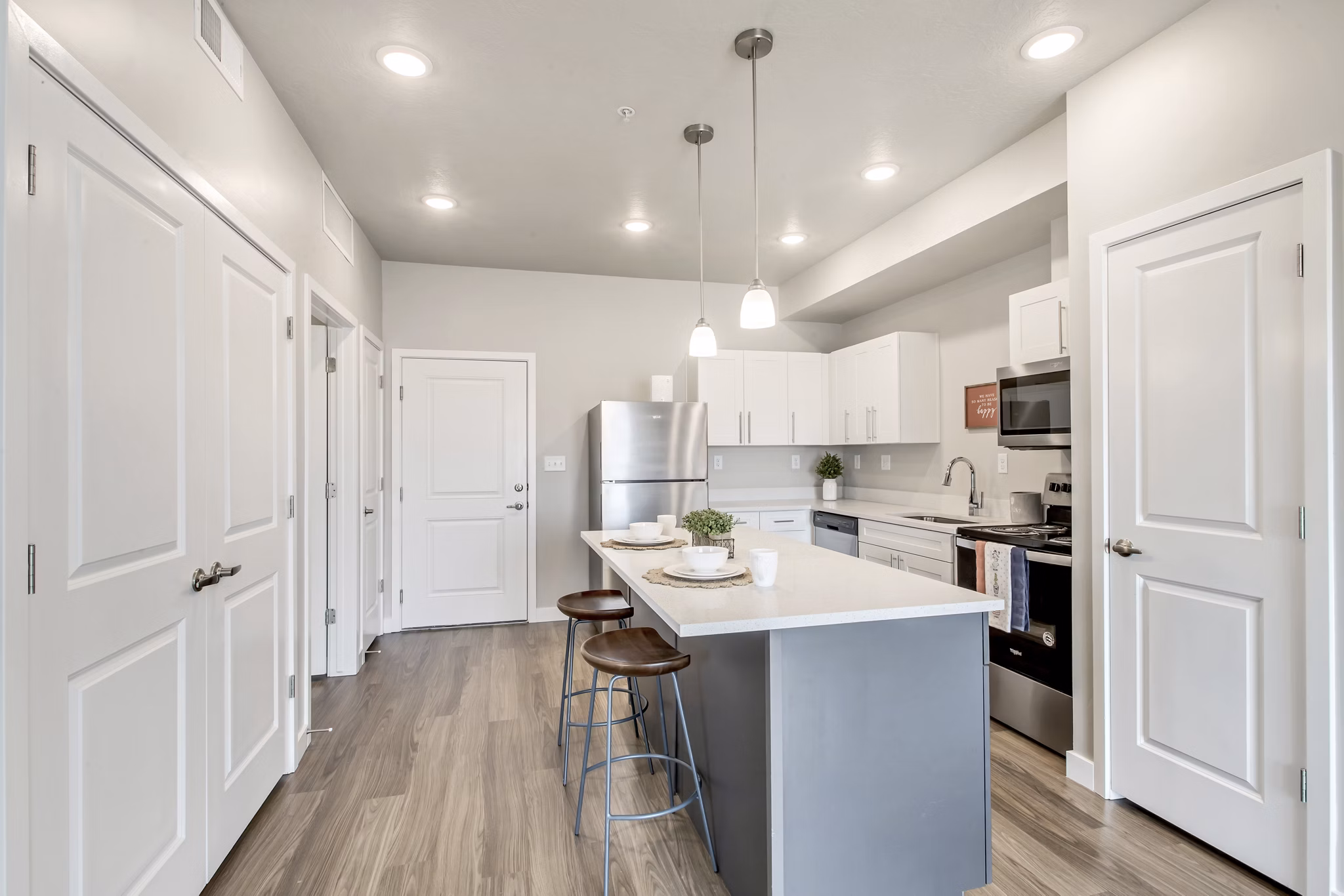 Modern kitchen with stainless steel appliances and sleek cabinetry in Millpond Apartments, luxury residences