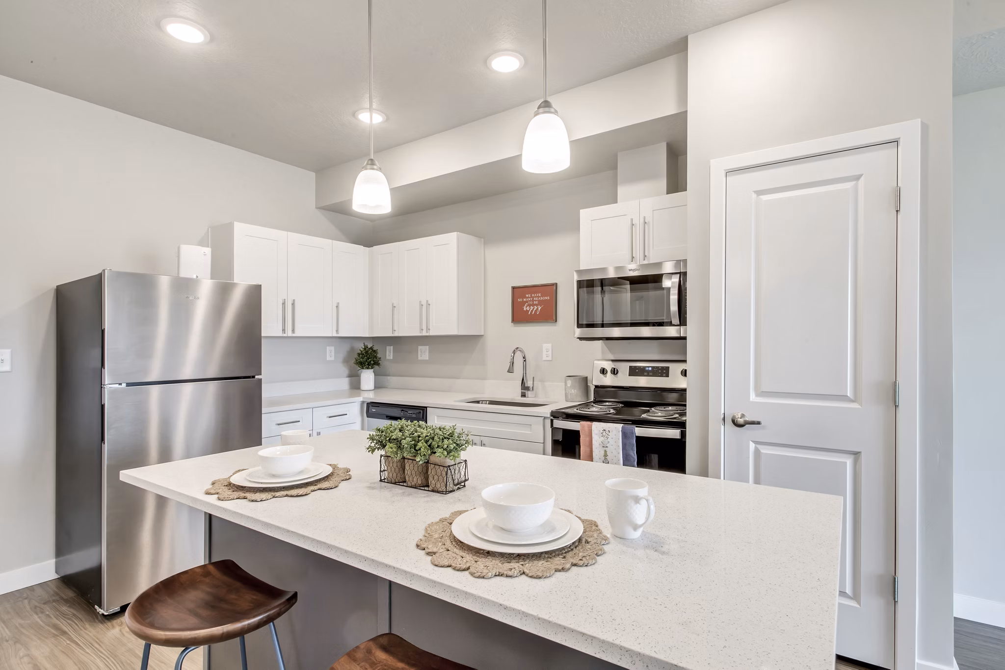 Modern kitchen with stainless steel appliances at Millpond Apartments