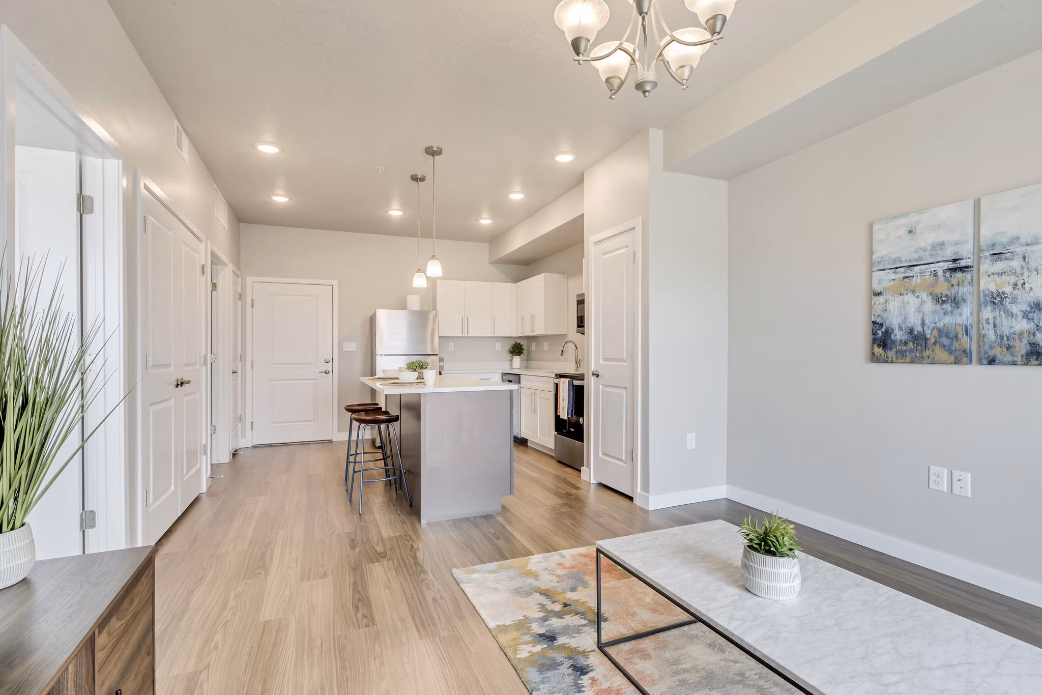 Contemporary living room with plush seating and natural light at Millpond Apartments