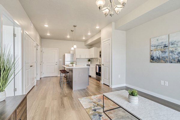 Contemporary living room with plush seating and natural light at Millpond Apartments