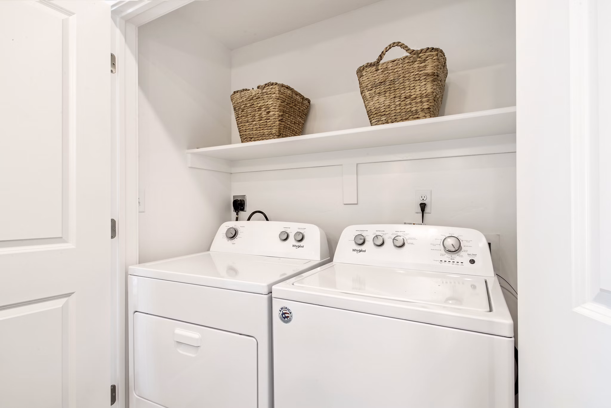 Laundry room featuring high-efficiency washers and dryers at Millpond Apartments