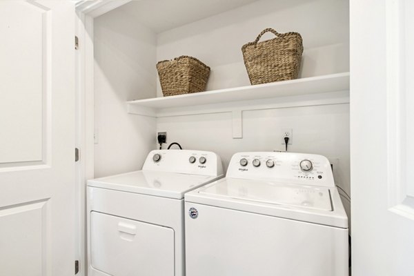 Laundry room featuring high-efficiency washers and dryers at Millpond Apartments