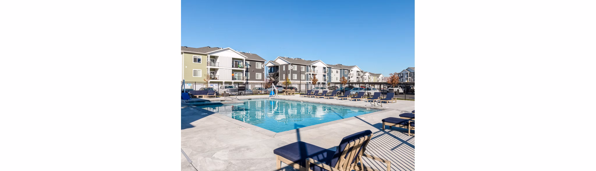 Relaxing poolside oasis at Millpond Apartments, offering luxury living with modern amenities