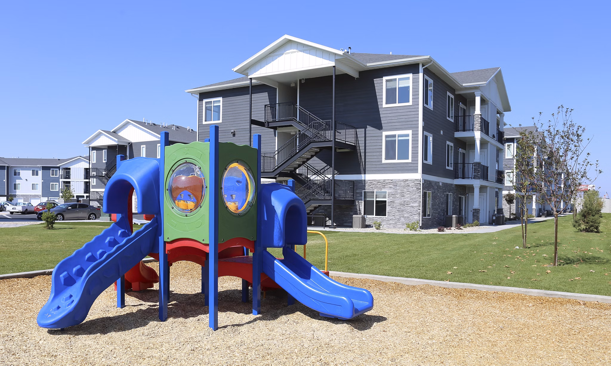 Modern playground featuring colorful equipment at Millpond Apartments