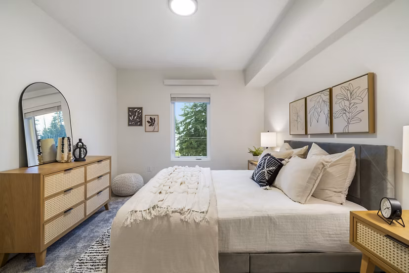Cozy bedroom with plush bedding and modern decor at The Oliveen Apartments