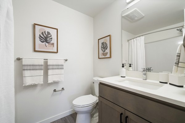 Spacious bathroom with modern fixtures at The Oliveen Apartments