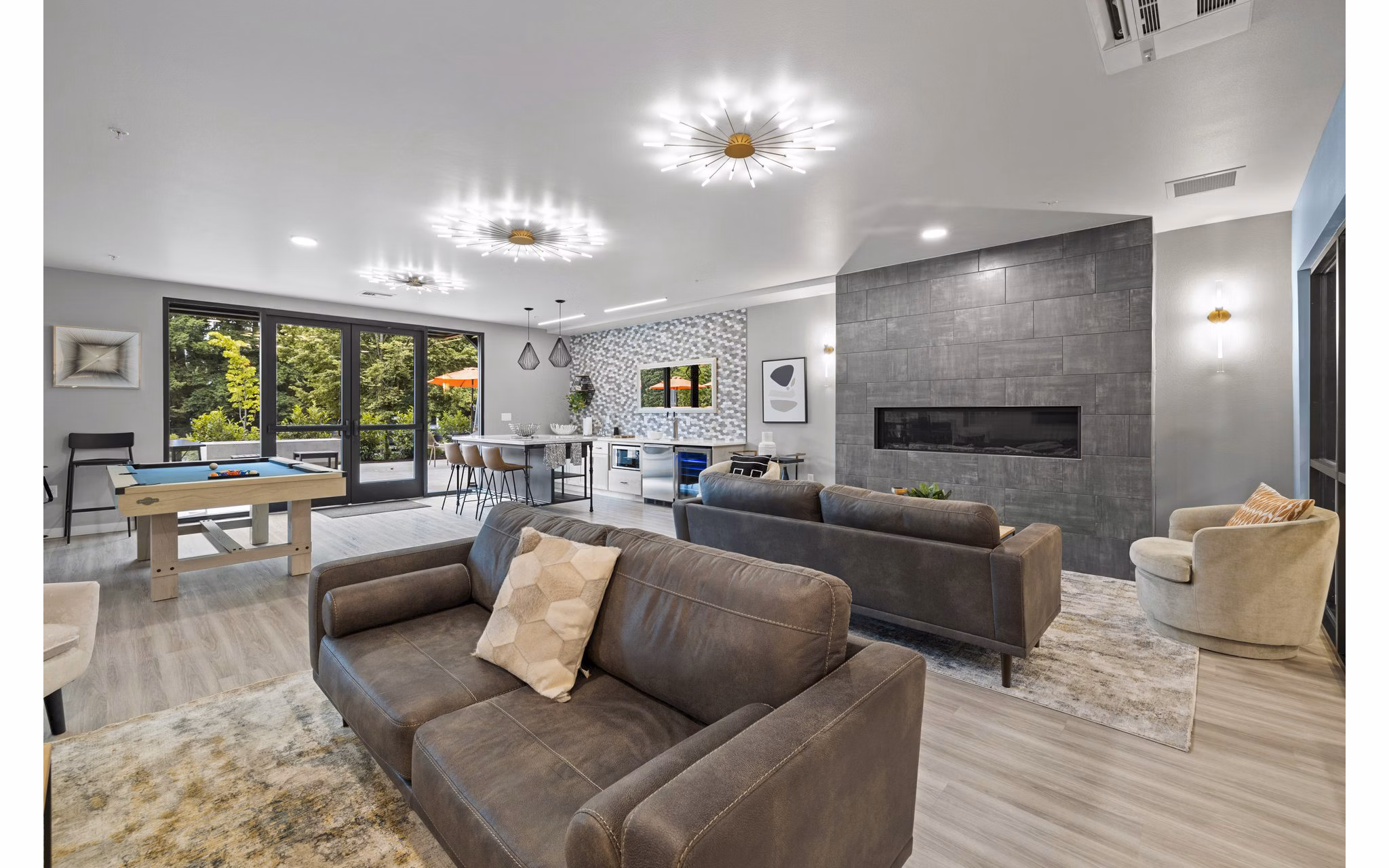 Clubhouse with modern furnishings at The Oliveen Apartments, offering a luxurious living experience