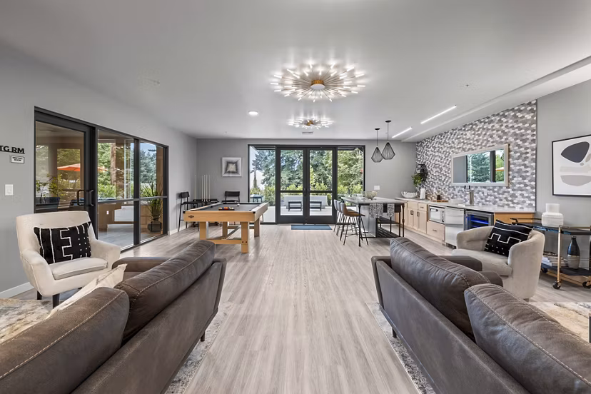 Clubhouse game room featuring pool table and comfy seating at The Oliveen Apartments