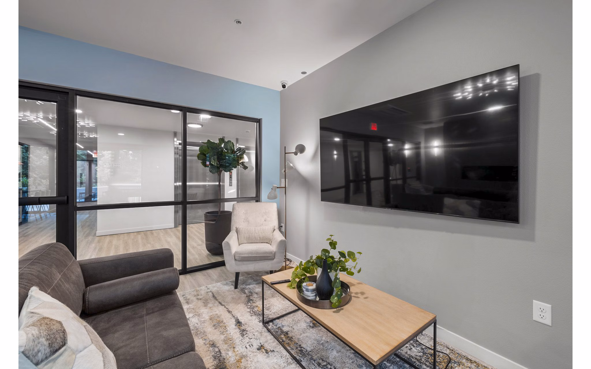 Clubhouse featuring modern decor and communal seating at The Oliveen Apartments