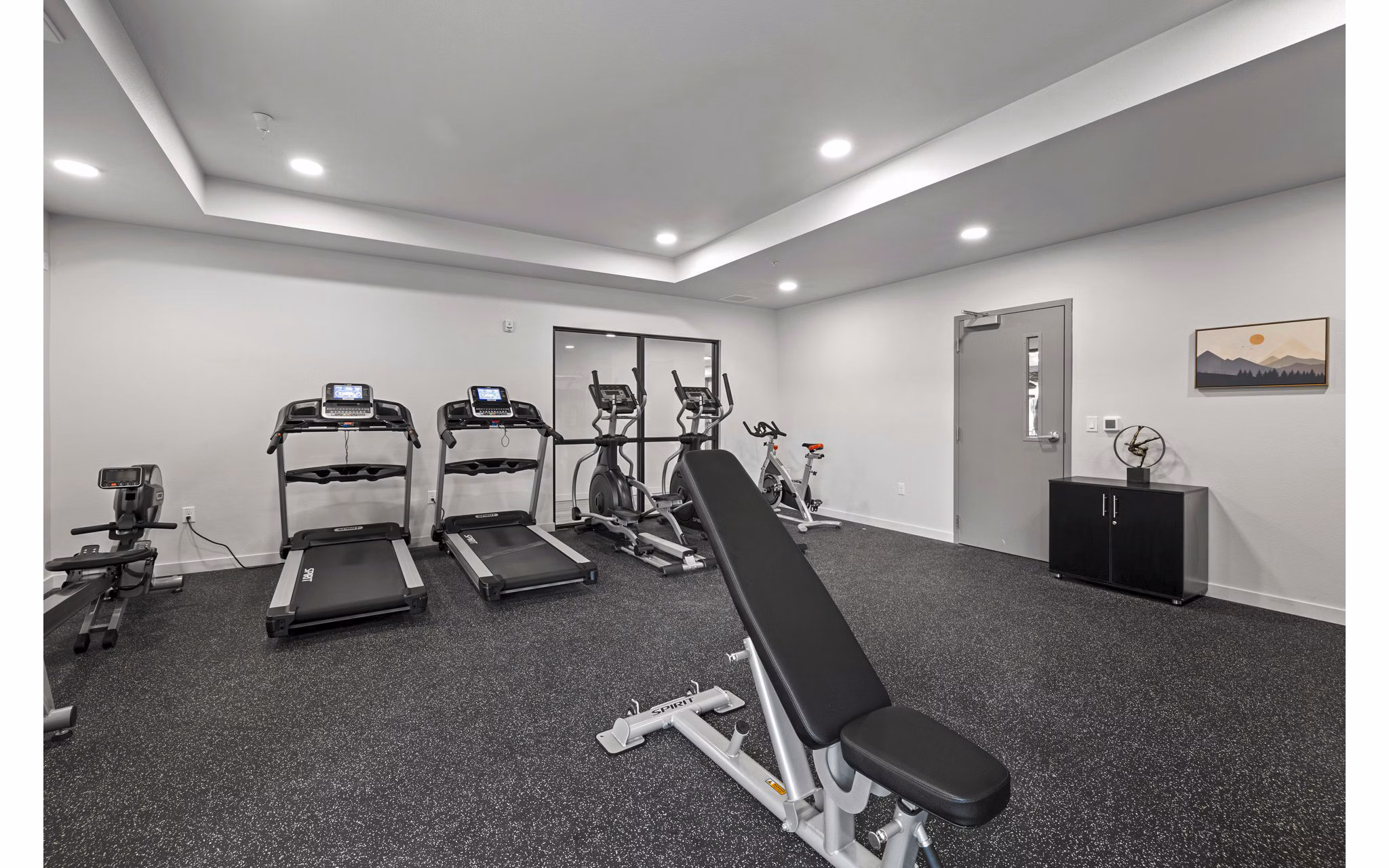 Modern fitness center featuring state-of-the-art equipment at The Oliveen Apartments