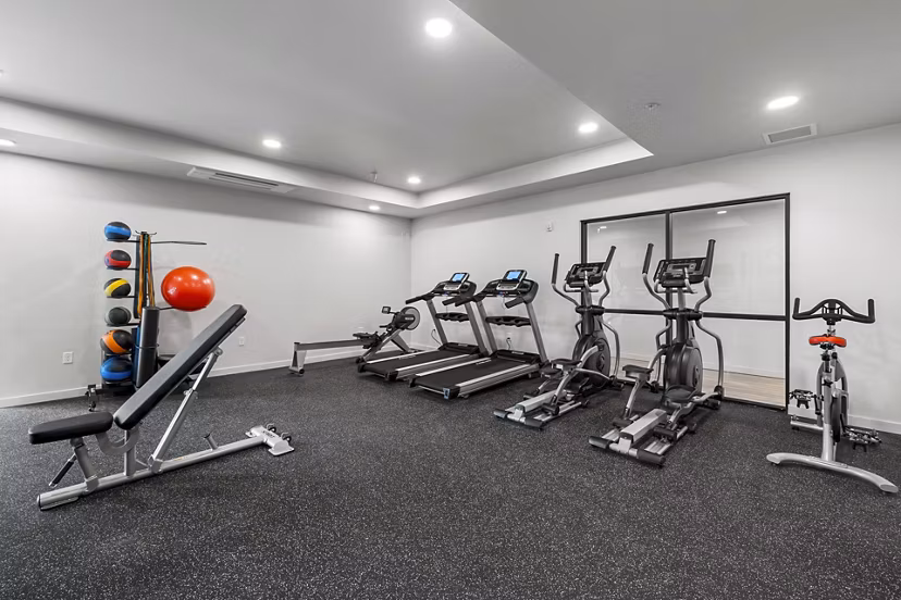 State-of-the-art fitness center featuring modern equipment at The Oliveen Apartments