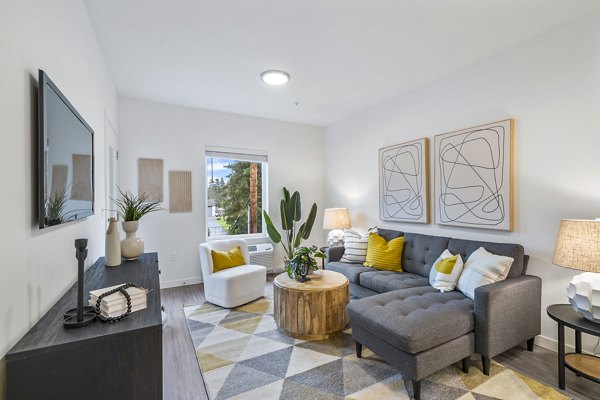 Spacious living room with modern decor in The Oliveen Apartments