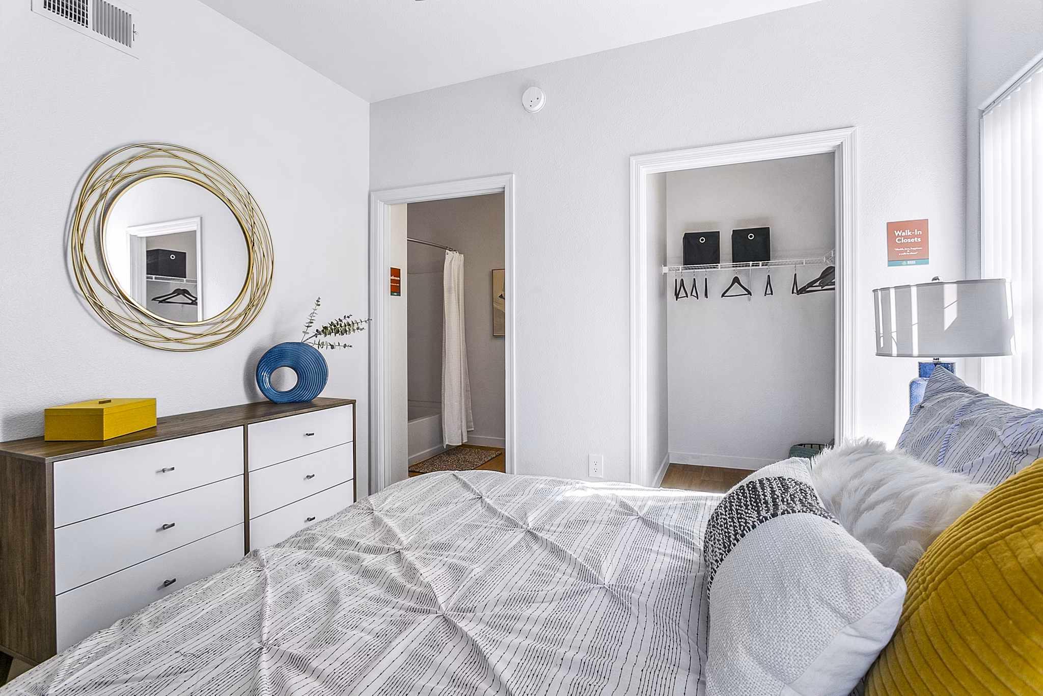 Cozy bedroom featuring modern furnishings and natural lighting in Morada Rise Apartments