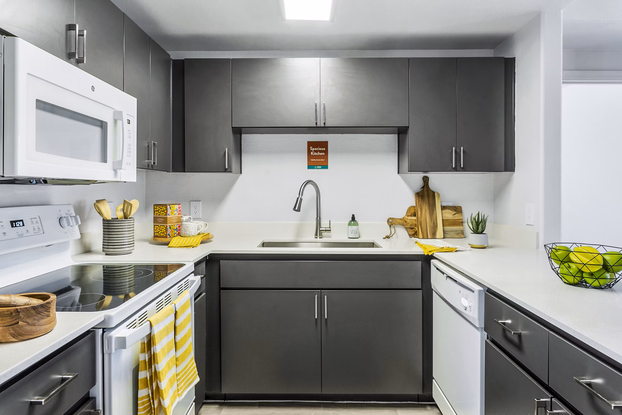 Modern kitchen with sleek cabinetry and stainless steel appliances in Morada Rise Apartments