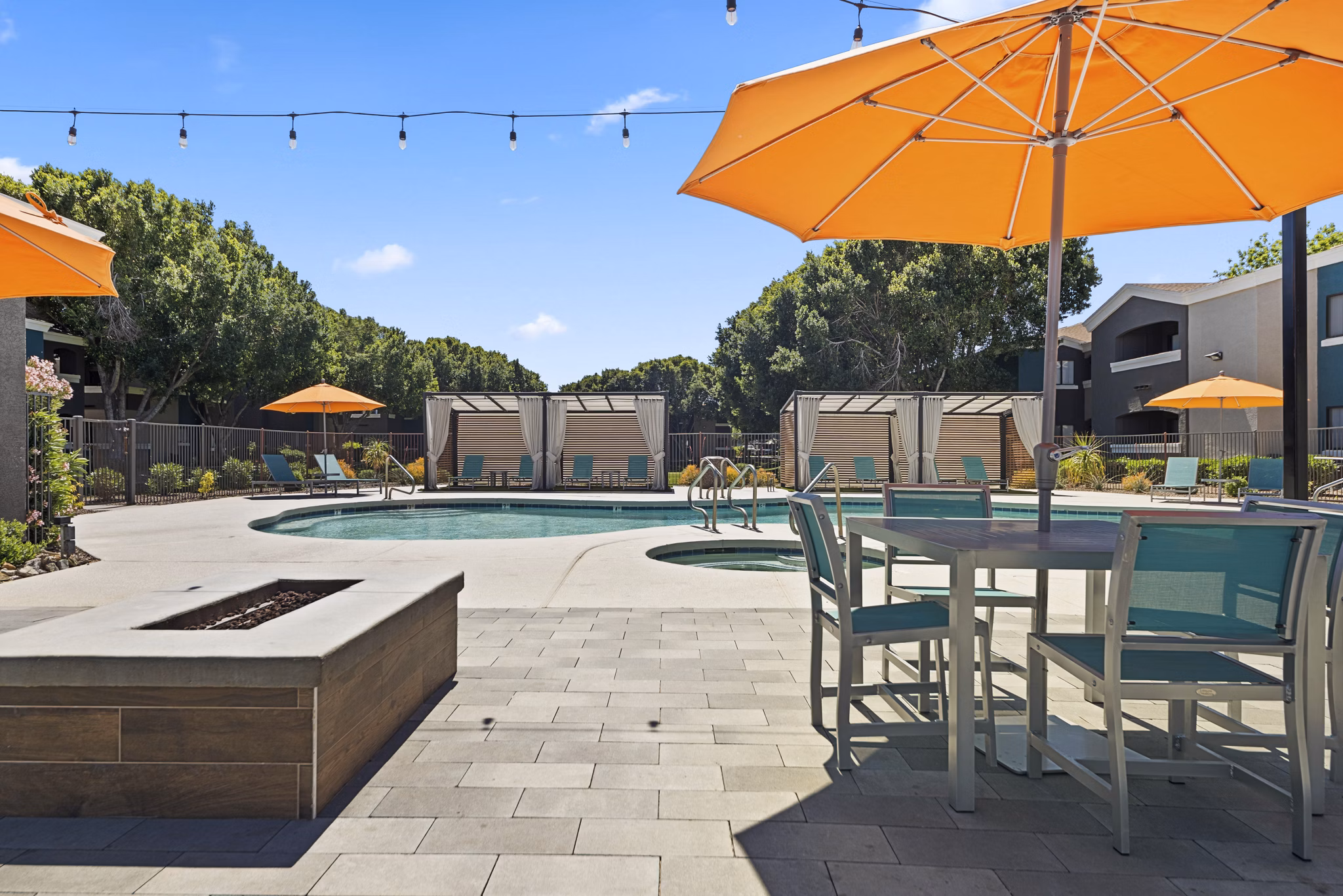 Resort-style pool with lounge areas at Morada Rise Apartments