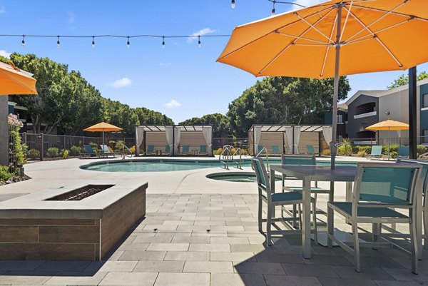 Resort-style pool with lounge areas at Morada Rise Apartments